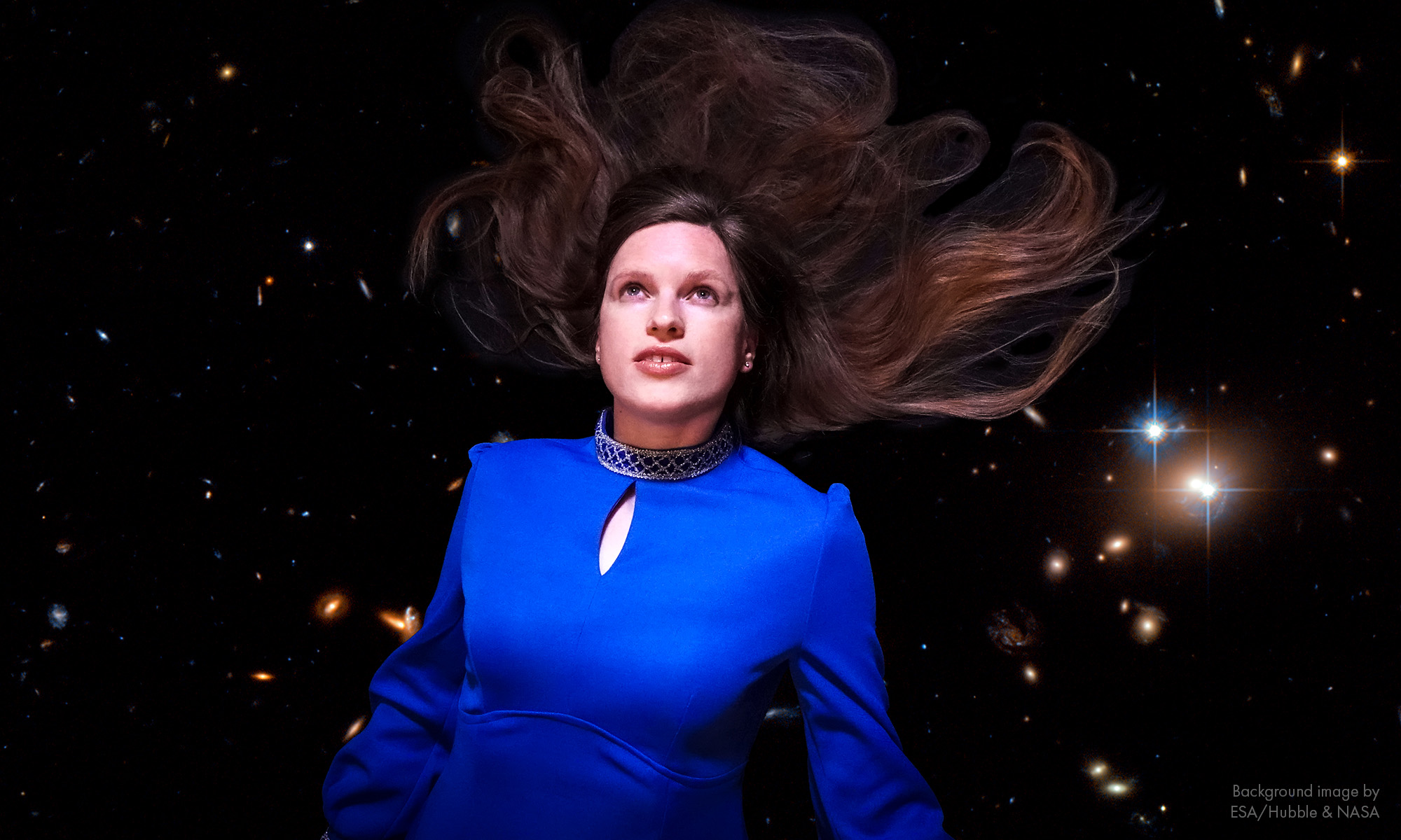 Maaike Siegerist floating in space, in a blue, sixties-style dress